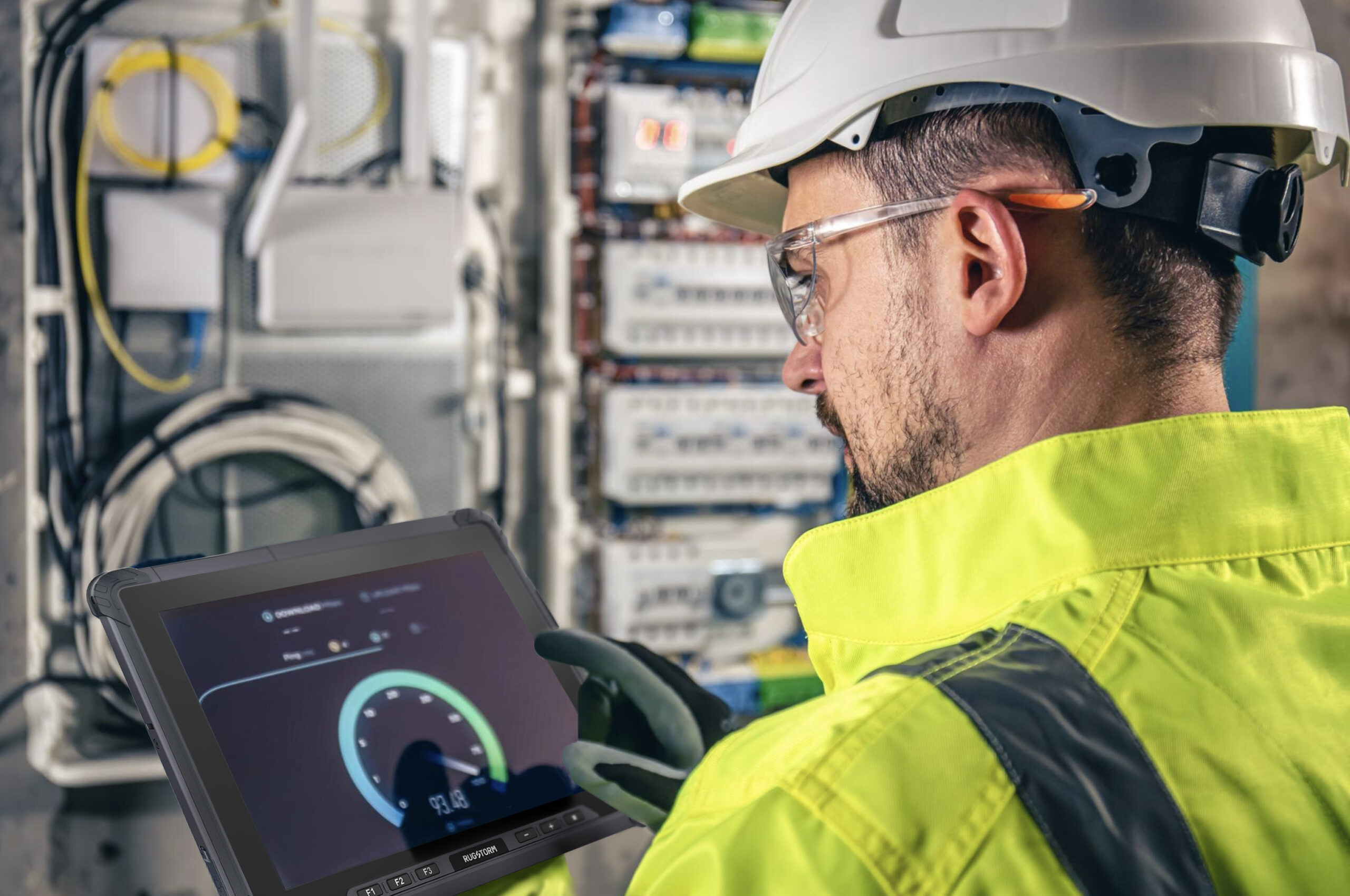 a worker in yellow uniform holding a rugged tablet doing defect checking