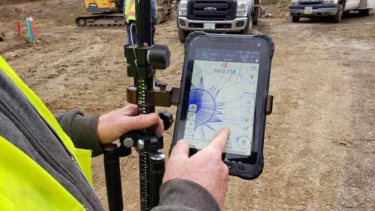 a man doing gis survey with a rugged android tablet