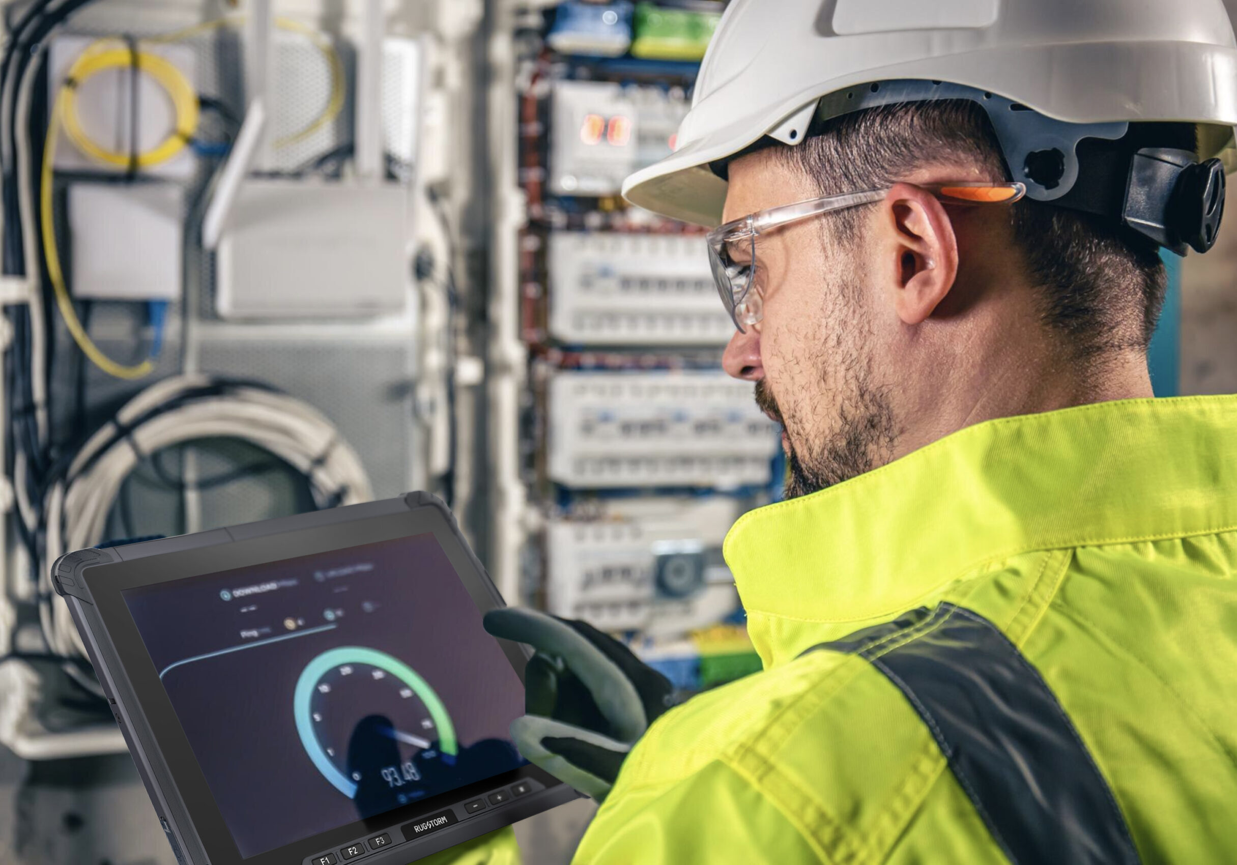 a worker in yellow uniform holding a rugged tablet doing defect checking