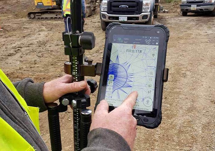 a man doing gis survey with a rugged android tablet